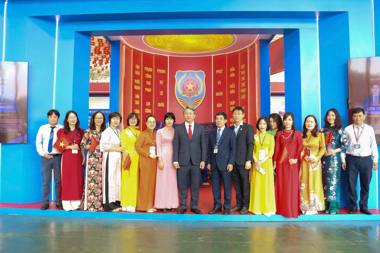 Bộ trưởng Nguyễn Hải Ninh chụp ảnh lưu niệm c&ugrave;ng c&aacute;c c&aacute;n bộ tại gian triển l&atilde;m của Bộ Tư ph&aacute;p