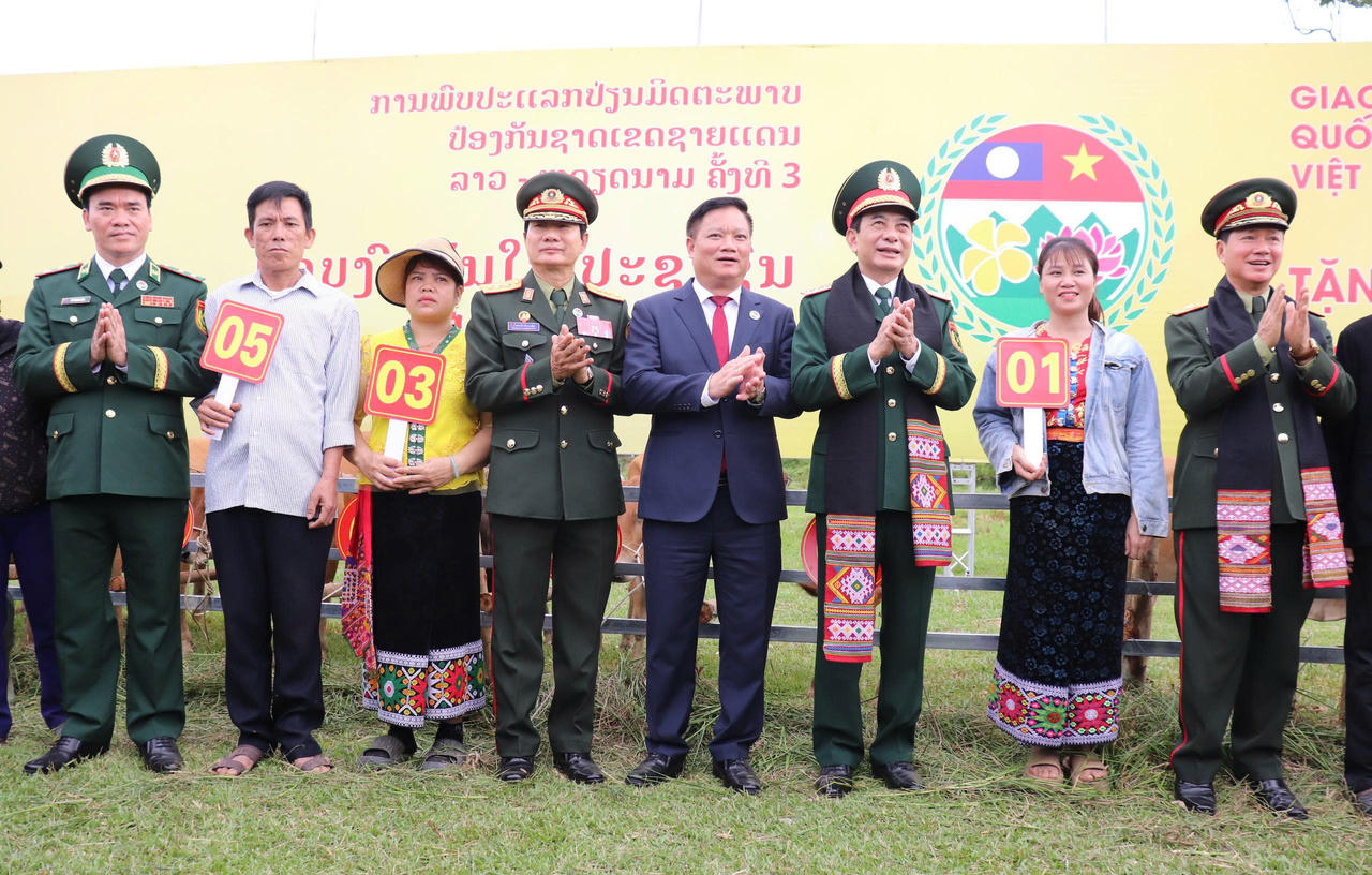 Hai Bộ trưởng Quốc ph&ograve;ng Việt Nam v&agrave; L&agrave;o trao b&ograve; giống cho nh&acirc;n d&acirc;n bi&ecirc;n giới x&atilde; Kim Bảng.